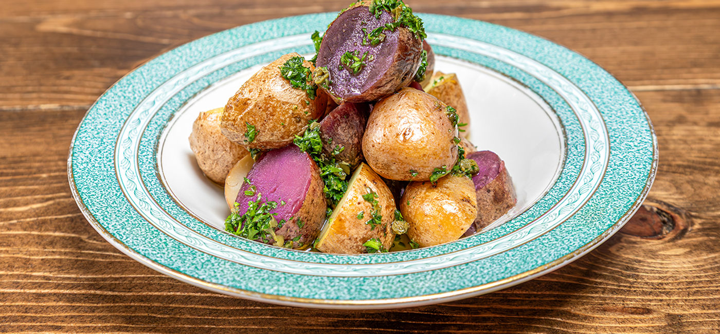 Image: Dutch baby potatoes with salsa verde. (Photo Credit: American Airlines Media)