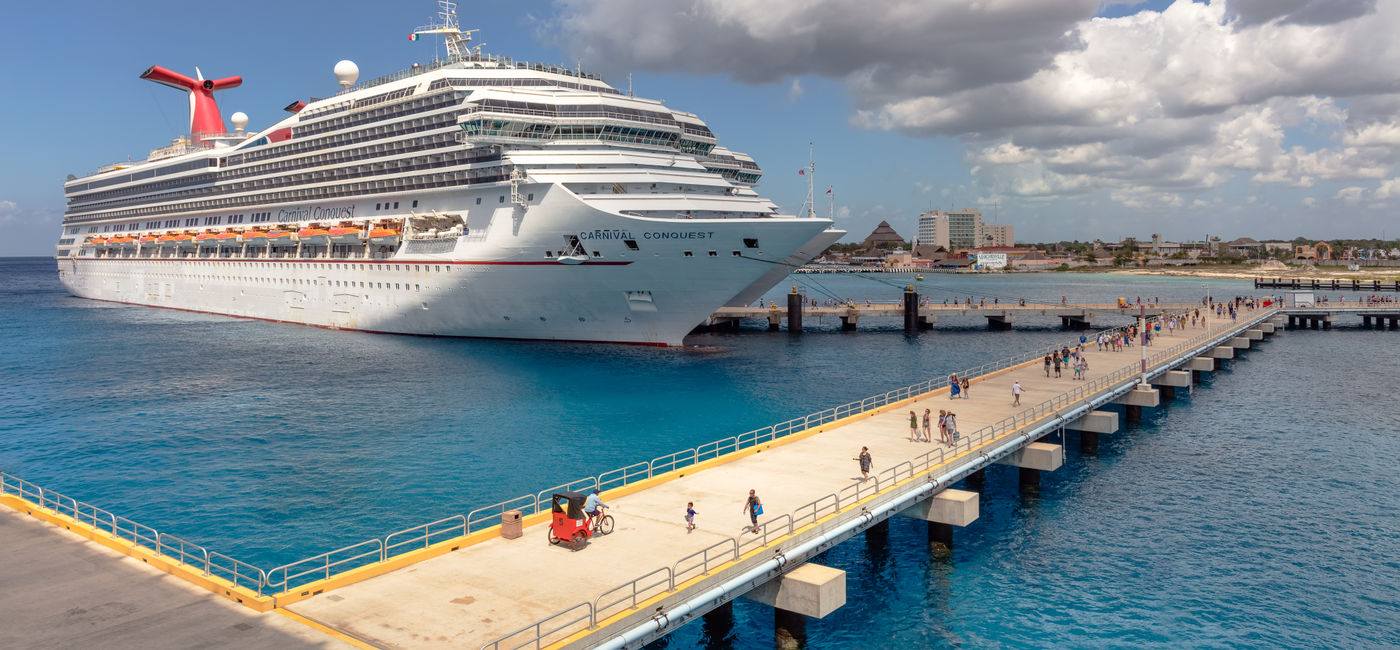 Image: Carnival Conquest docked in Cozumel. (Photo Credit: Sergey / Adobe Stock)