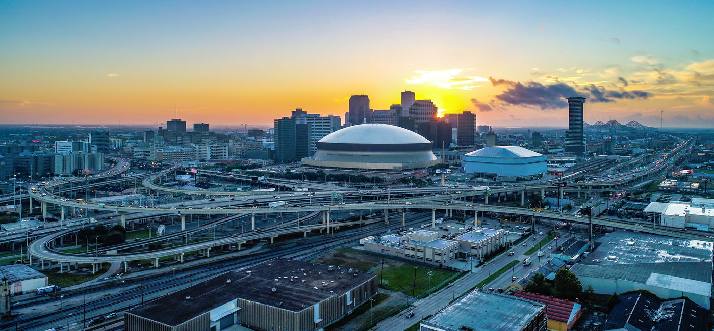 Image: Aerial view of New Orleans, Louisiana skyline at sunrise. (Photo Credit: Kevin Ruck/Adobe Stock)