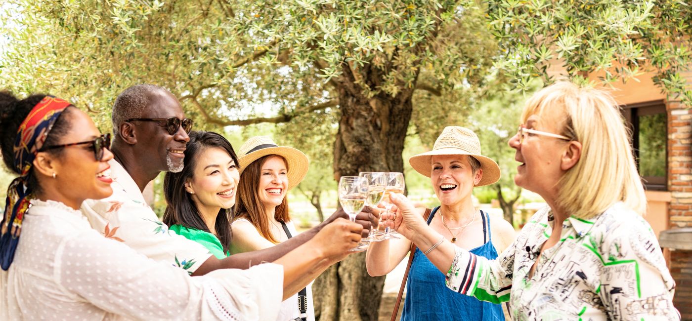 Image: A private tour group enjoys wine in Greece. (Photo Credit: TTC Tour Brands)