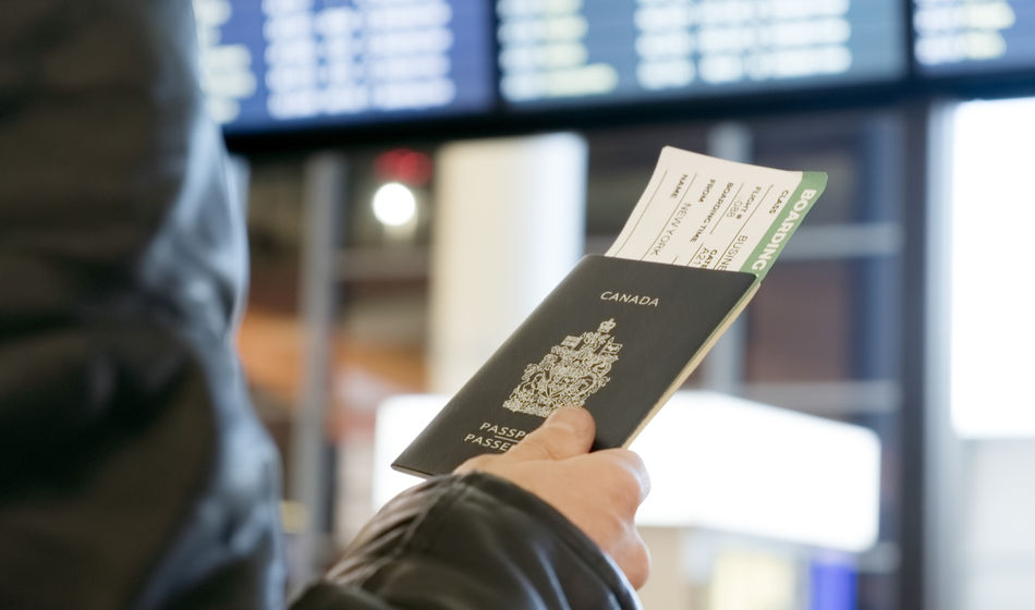 Man with Canadian passport and boarding pass