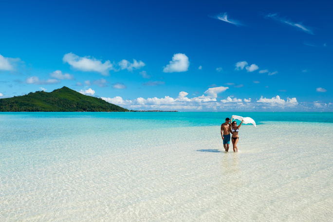 Couple on the beach at Conrad Bora Bora Nui, Motu Tapu, French Polynesia. Couple on the beach at Conrad Bora Bora Nui, Motu Tapu, French Polynesia.