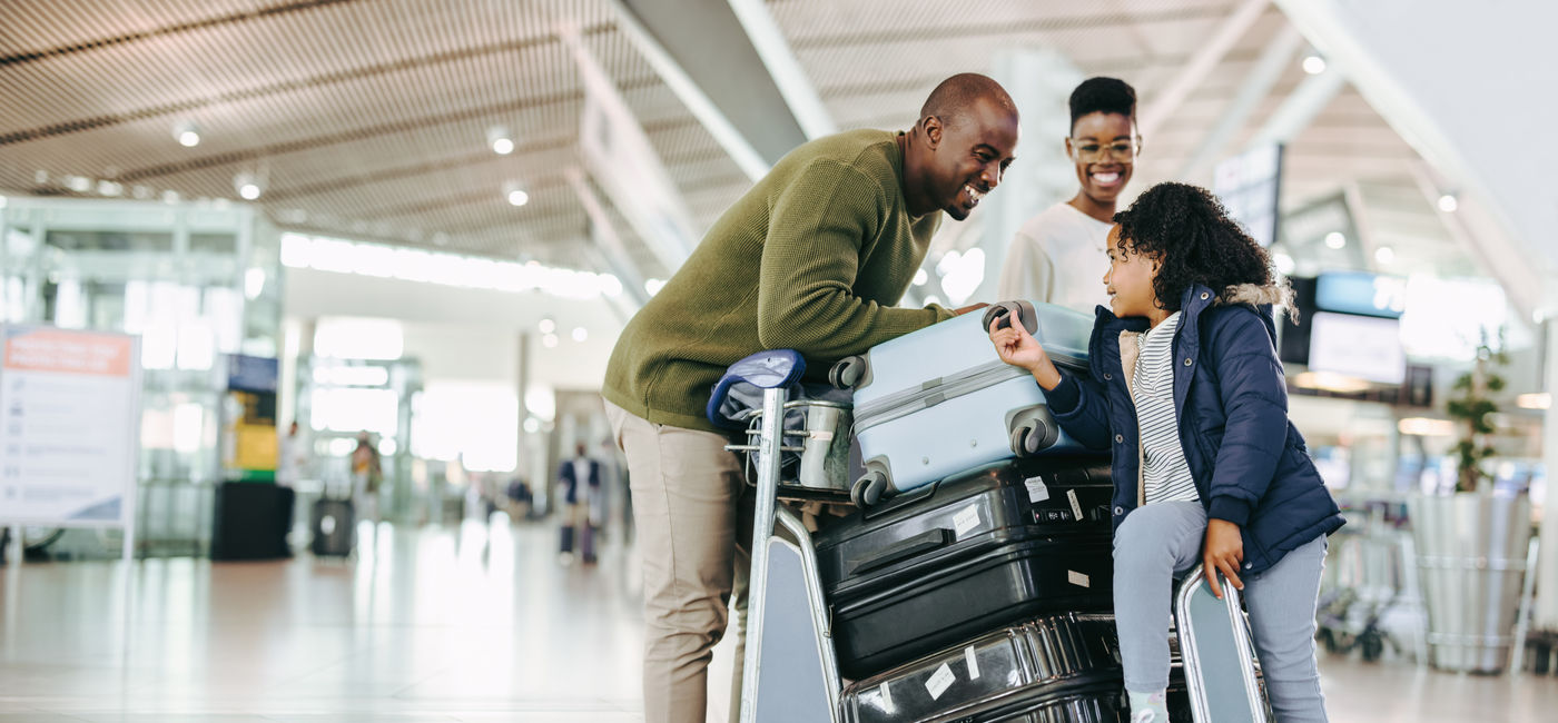 Image: Family preparing for travel at the airport. (Photo Credit: Jacob Lund/Adobe)