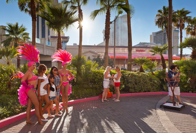 Showgirls posing with tourists in Las Vegas Showgirls posing with tourists in Las Vegas