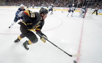 Vegas Golden Knights left wing Erik Haula (56) is chased by Winnipeg Jets defenseman Toby Enstrom (39) during Game 4 of their NHL hockey Western Conference Final game Friday, May 18, 2018, at T-Mobile Arena.