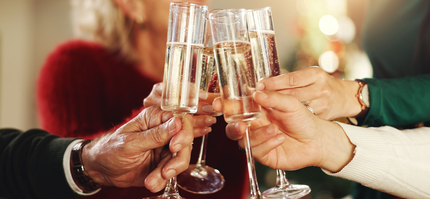 Image: Toasting with champagne glasses. (Photo Credit: Adobe Stock/peopleimages.com)