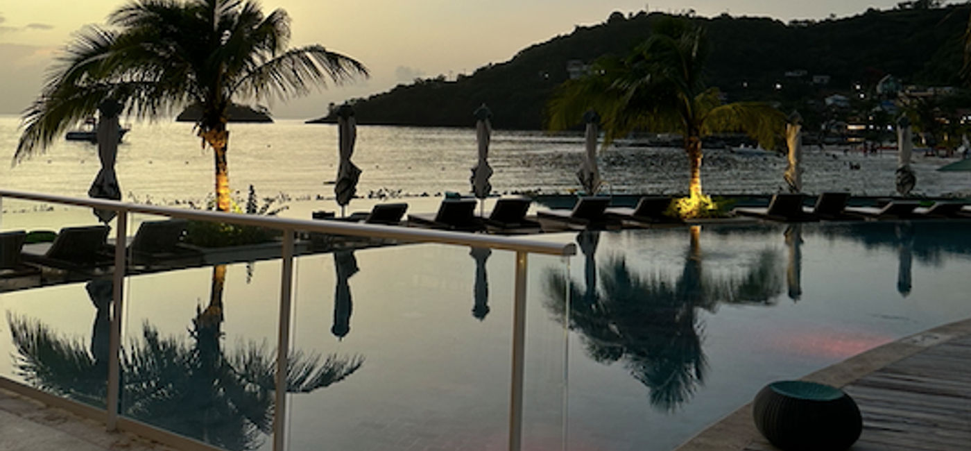 Image: A nighttime view of the infinity pool beside Parisol Beach Club Bar at Sandals Saint Vincent and the Grenadines. (Photo Credit: Marsha Mowers)