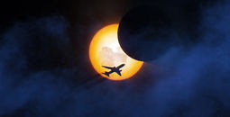 Plane in flight during solar eclipse 