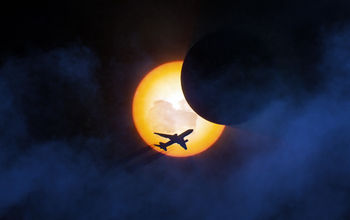 Plane in flight during solar eclipse 