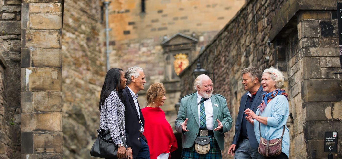Image: A local expert with a Brendan Vacations group at Edinburgh Castle in Scotland. (Photo Credit: TTC Tour Brands)