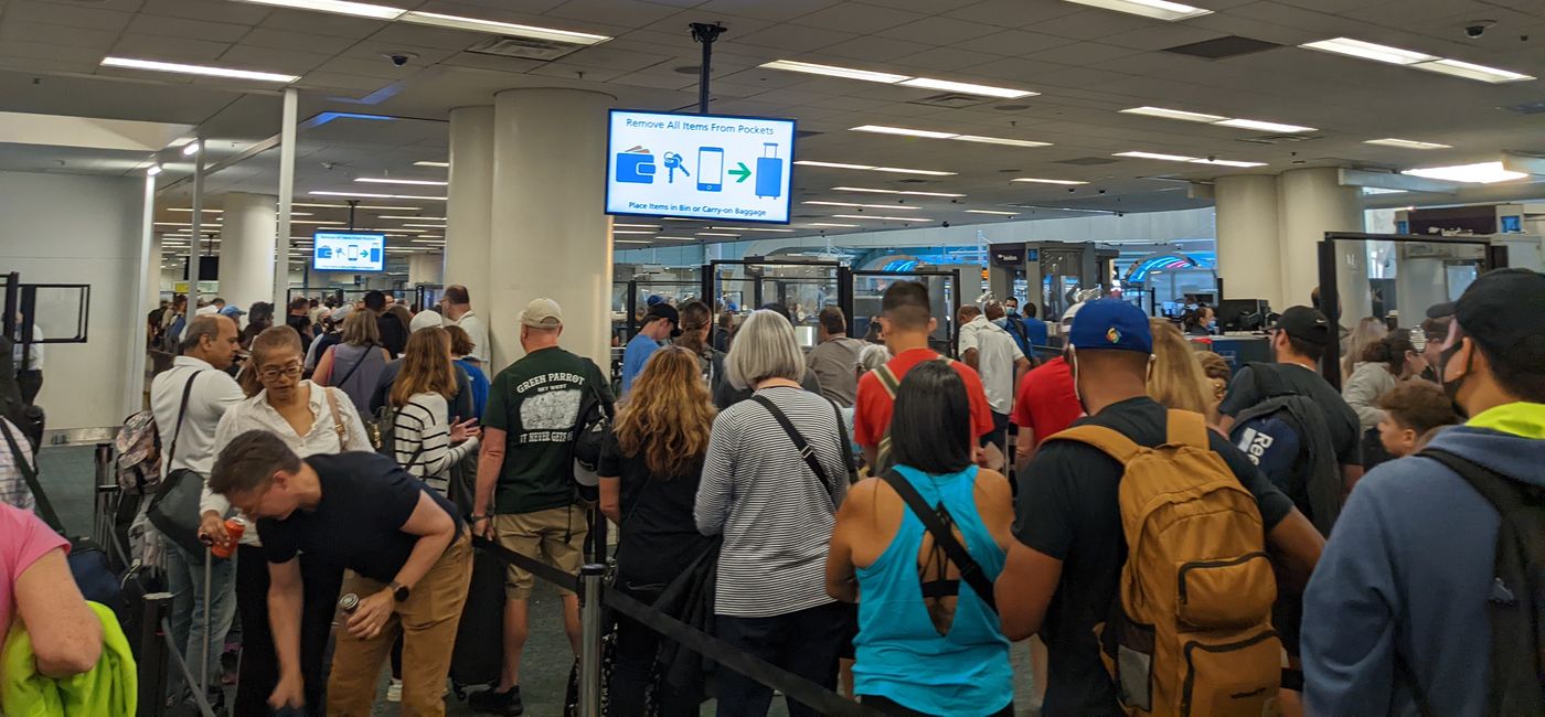 Image: Travelers wait to go through TSA security at the airport (photo by Eric Bowman)