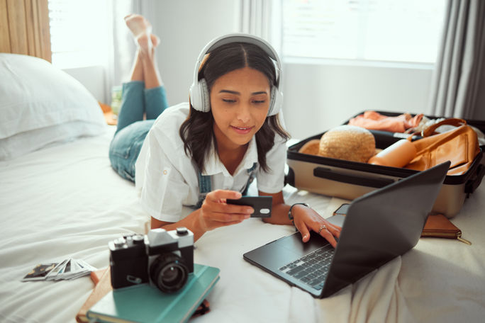 A woman booking travel with a credit card