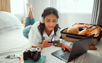A woman booking travel with a credit card