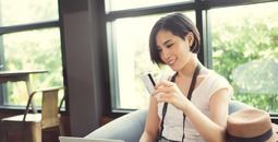 Woman holding credit card at coffe shop (Photo via torwai / iStock / Getty Images Plus)