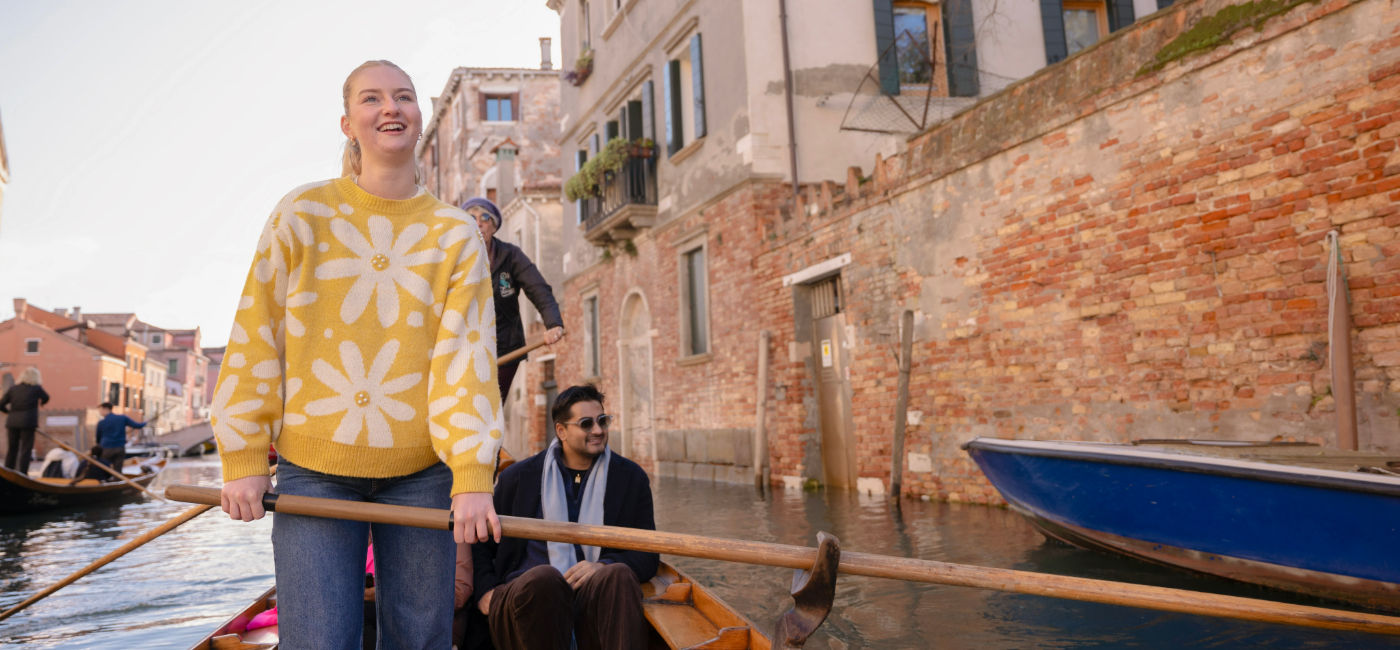 Image: A young woman rides on a gondola on a Contiki trip. (Photo Credit: Contiki)