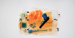 Xray of luggage with a hidden pistol, TSA, gun, handgun, firearm, airport,