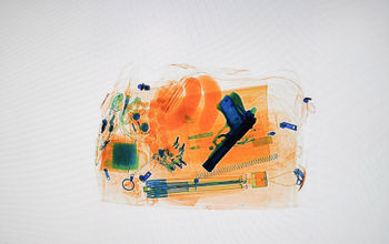 Xray of luggage with a hidden pistol, TSA, gun, handgun, firearm, airport,