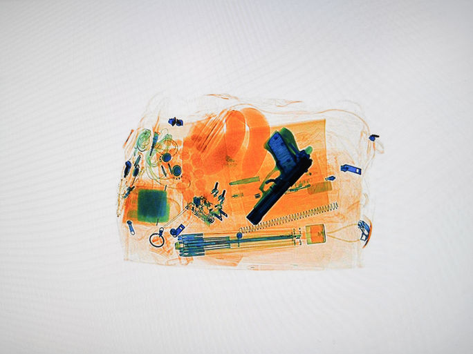 Xray of luggage with a hidden pistol Xray of luggage with a hidden pistol, TSA, gun, handgun, firearm, airport,