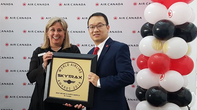 Lucie Guillemette, Air Canada CCO, and Andrew Yiu, Air Canada vice president of Product, hold the airline's 2018 Skytrax award for Best Airline in North America.