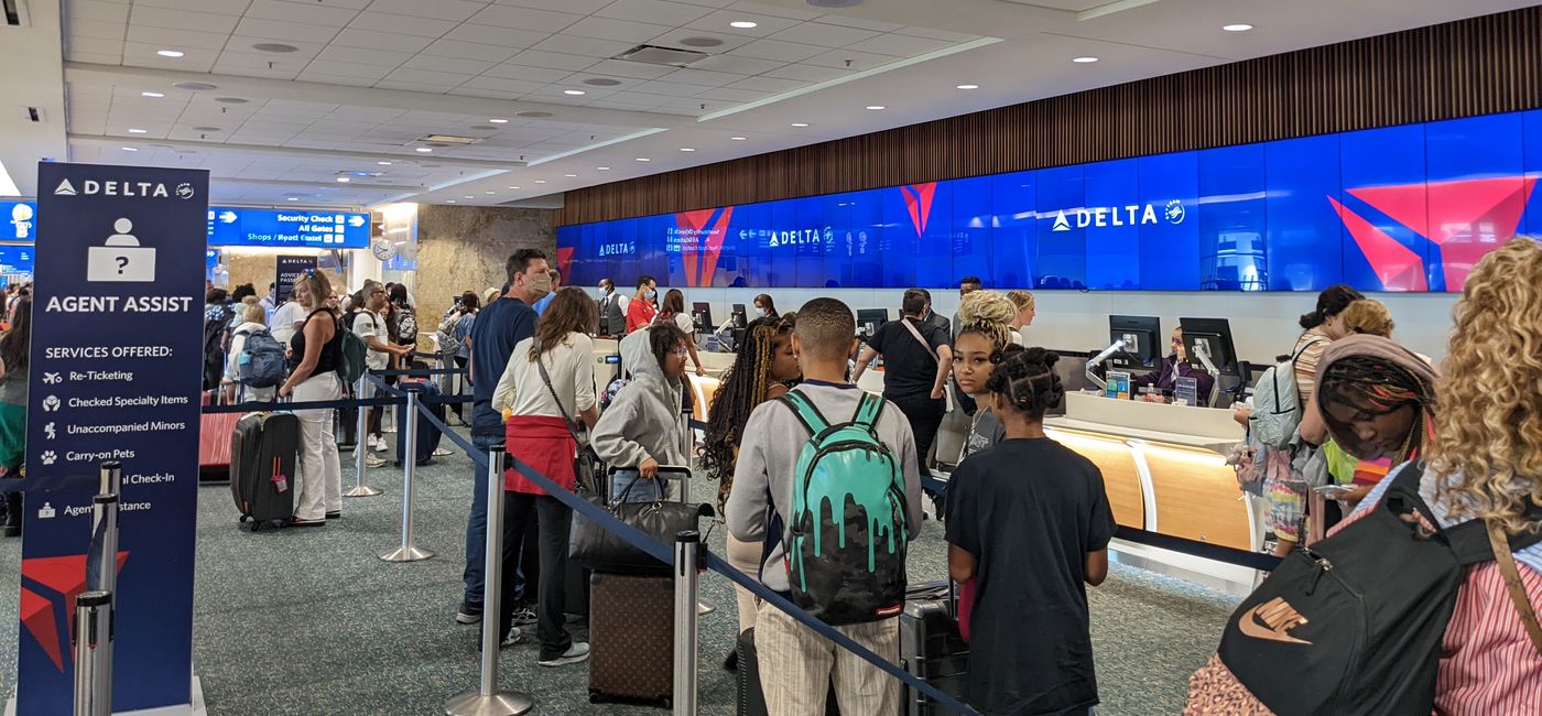 Image: Travelers waiting in line at the airport. (photo by Eric Bowman)