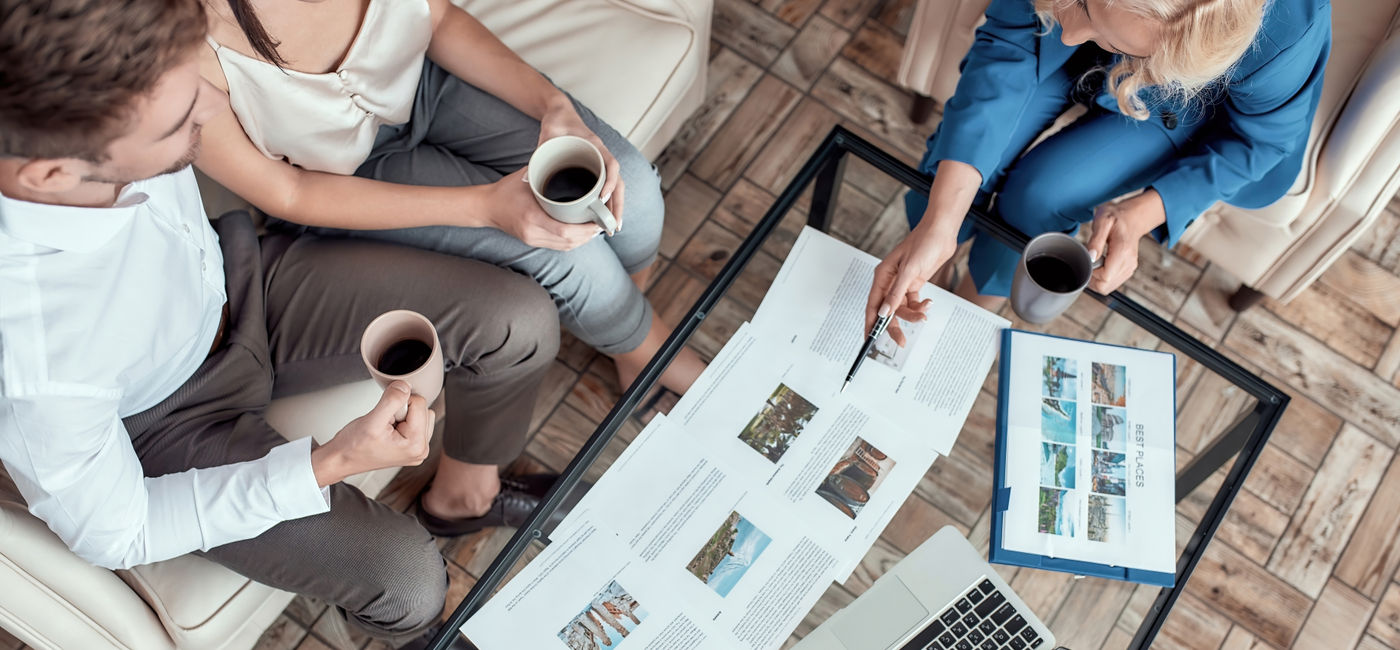 Image: Travel advisor working with clients. (Photo Credit: Svitlana/Adobe)