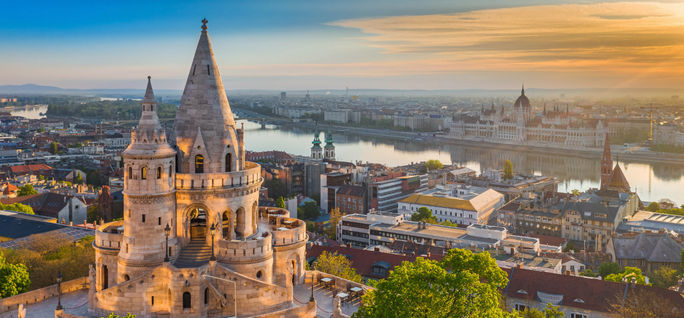 The sunrise grows over the Danube and Fisherman's Bastion in Budapest. Adobe Stock, Danube, Budapest, Fisherman's Bastion, Hungarian parliament