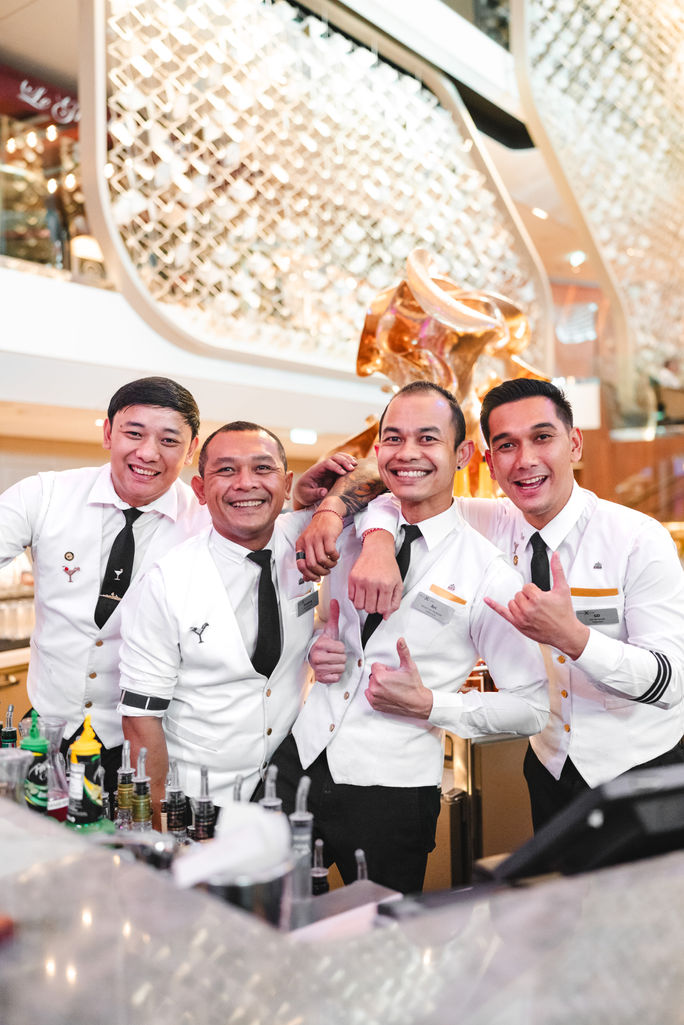 Flair bartenders serve at the Grand Atrium Martini Bar aboard Celebrity Beyond.
