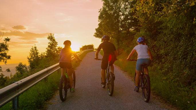 Travelers explore the rural landscape on electric bikes at sunrise. Travelers explore the rural landscape on electric bikes at sunrise.