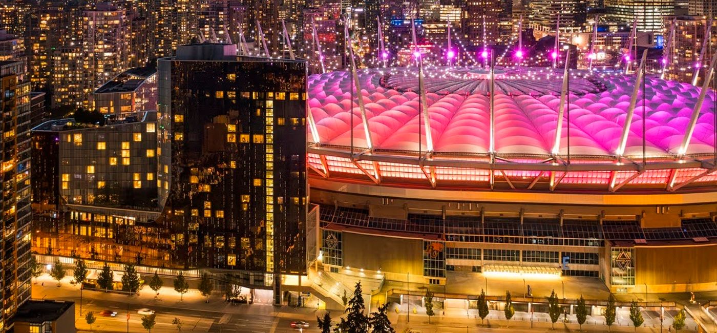 Image: The Douglas Hotel and JW Marriott Parq Vancouver (left, foreground) sit next to BC Place Stadium (right), Vancouver's FIFA World Cup venue. (Photo Credit: Marriott)