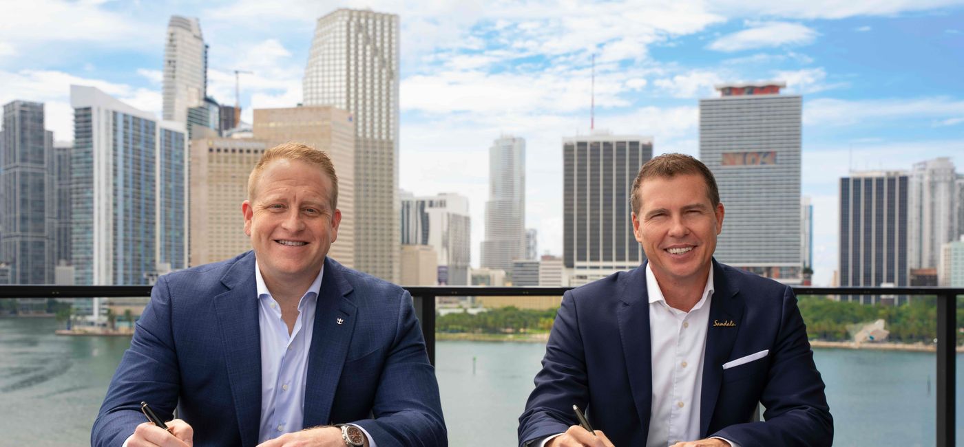 Image: Jason Liberty, Chairman and CEO of Royal Caribbean Group, and Adam Stewart, Executive Chairman of Sandals Resorts, mark the signing of an agreement (Photo Credit: Royal Caribbean)