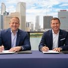 Jason Liberty, Chairman and CEO of Royal Caribbean Group, and Adam Stewart, Executive Chairman of Sandals Resorts, sign mega deal,