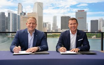 Jason Liberty, Chairman and CEO of Royal Caribbean Group, and Adam Stewart, Executive Chairman of Sandals Resorts, sign mega deal,