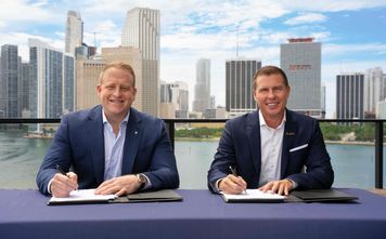 Jason Liberty, Chairman and CEO of Royal Caribbean Group, and Adam Stewart, Executive Chairman of Sandals Resorts, sign mega deal,