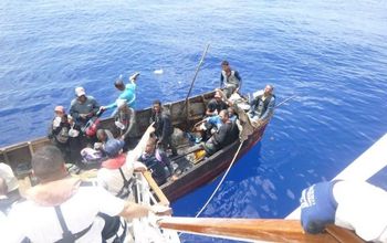 Carnival Paradise crew members saving stranded sailors. 