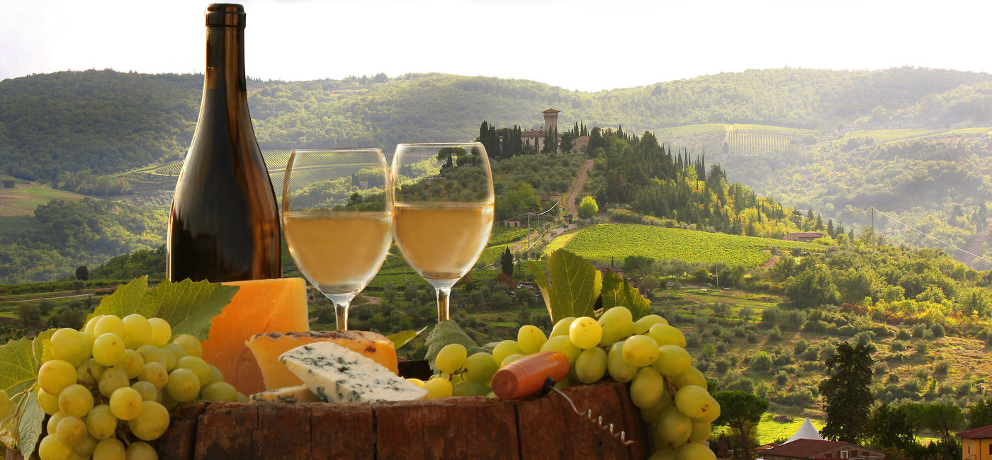 Image: Wine, grapes and cheese at a vineyard in Chianti, Tuscany, Italy. (Photo Credit: Adobe Stock/Tomas Marek)