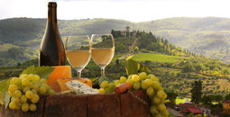 Wine, grapes and cheese at a vineyard in Chianti, Tuscany, Italy.