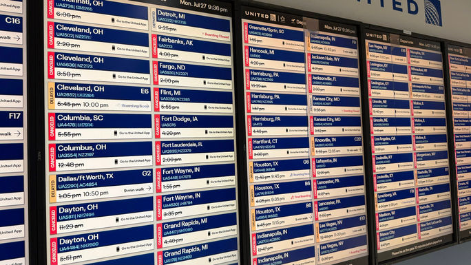 A monitor at Chicago's O'Hare International Airport shows multiple flight delays and cancellations. A monitor at Chicago's O'Hare International Airport shows multiple flight delays and cancellations.