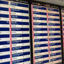 A monitor at Chicago's O'Hare International Airport shows multiple flight delays and cancellations.