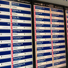 A monitor at Chicago's O'Hare International Airport shows multiple flight delays and cancellations.