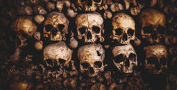 Human skulls and bones stacked up inside the Paris catacombs. 