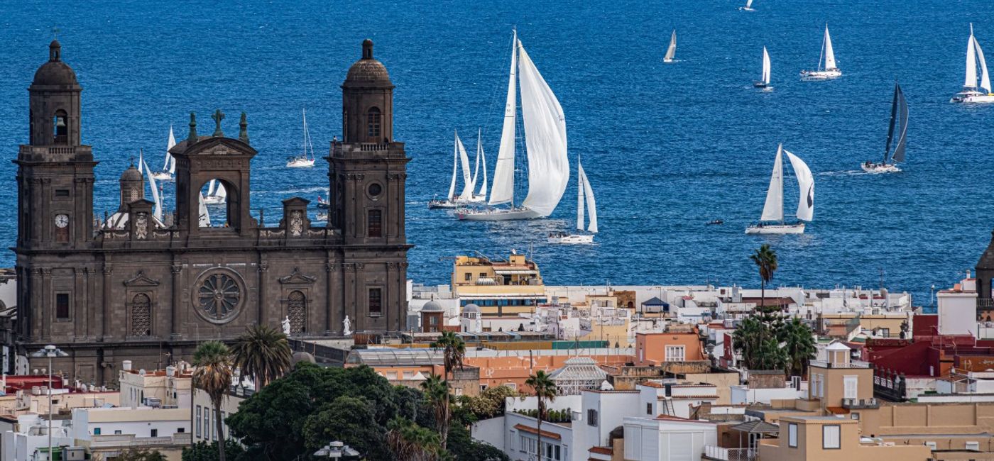 Image: The Cathedral of Santa Ana in the historic Vegueta quarter, with sailing boats off the coast of Las Palmas.