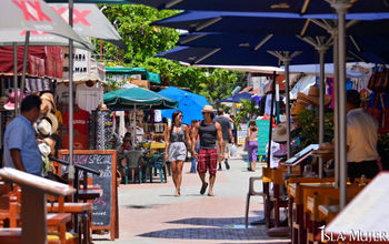 Tourists stroll through a market on Isla Mujeres, Quintana Roo, Mexico.