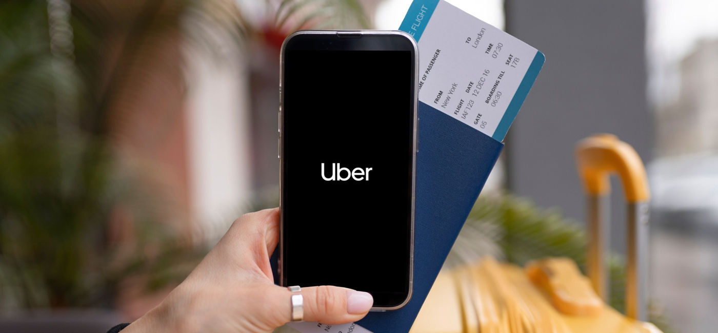 Image: Traveler using the Uber app. (Photo Credit: Uber)