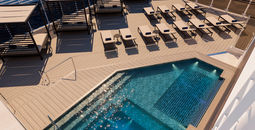 The MSC Yacht Club pool deck on MSC Magnifica