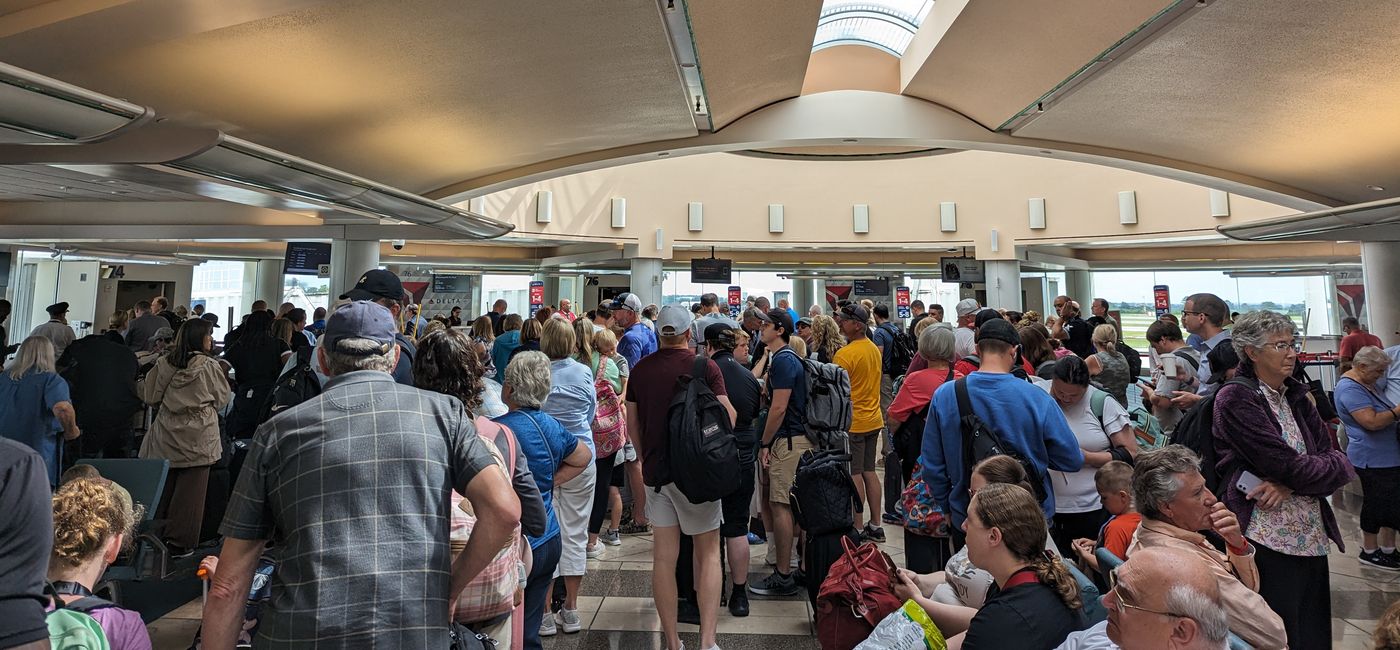 Image: Crowd of people waiting to board their flight (Photo Credit: Eric Bowman)