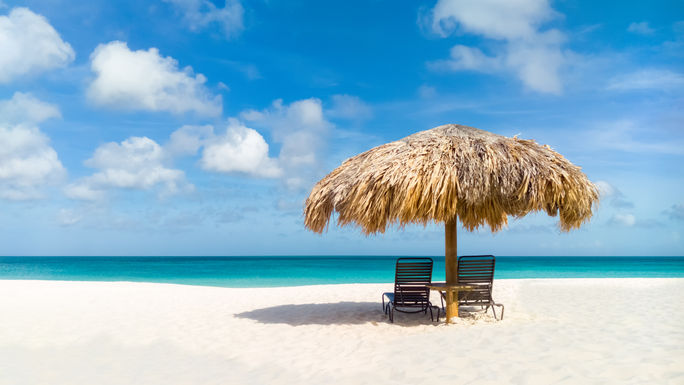 Umbrella on Eagle Beach, Aruba in the summer Umbrella on Eagle Beach, Aruba in the summer