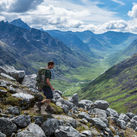 Hiker making his way down a steep trail in Alaska's Talkeetna Mountains.