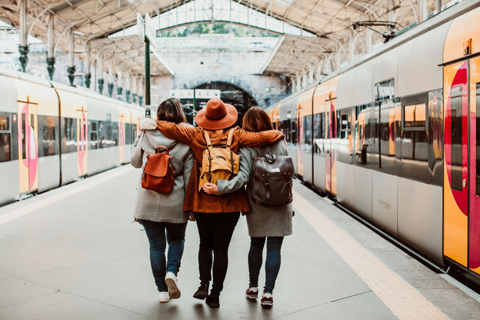 Travelers taking the train in Porto, Portugal. Adobe Stock, travelers, young adult travelers, gen z, millennial, porto, train, rail travel, train travel, portugal