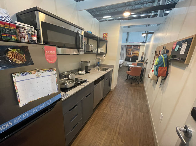 A model of the LivSmart guest room shows the full-size kitchen appliances that are a brand standard. 