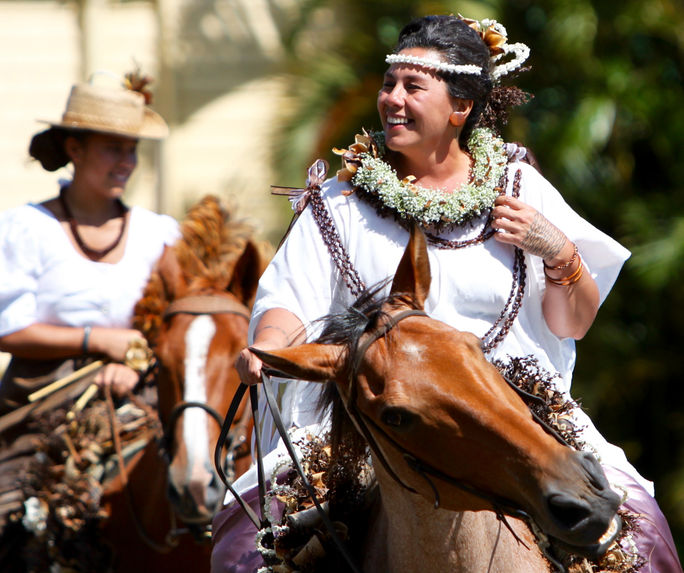 King Kamehameha Day Parade - North Kohala, Pau Queen Kuulei Keakealani Image of hawaiian woman adorned with flower lei riding a horse in a parade